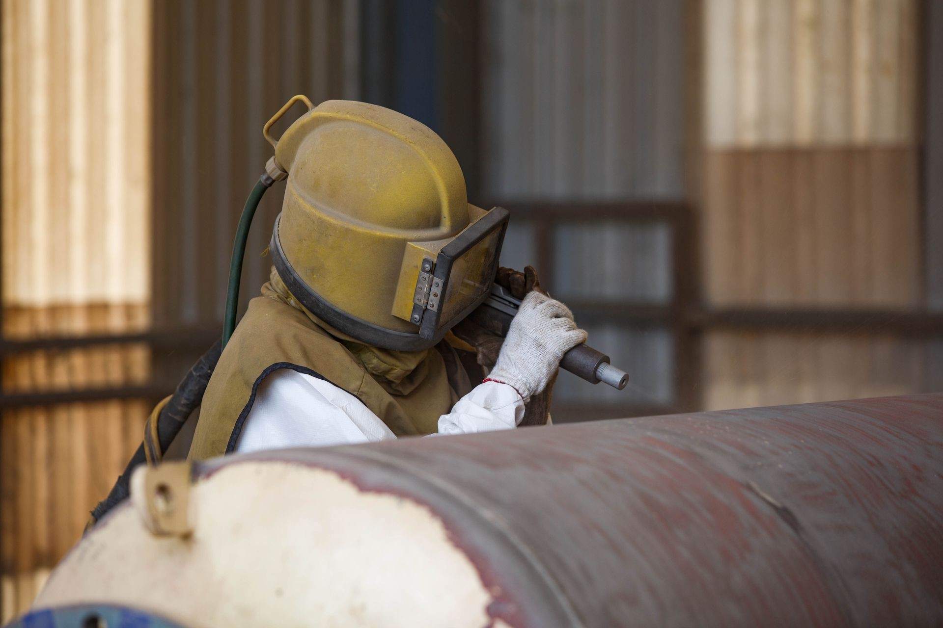 Sandblasting residential vehicles at our East Dundee location, preparing truck bodies for repair and repainting with professional-grade equipment