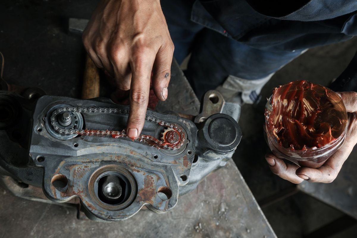 The mechanic serves the truck. Repair brake caliper. Close-up. Maintenance. Brake system. Chain mechanism of the support. Brake spare parts. Hands working close-up.
